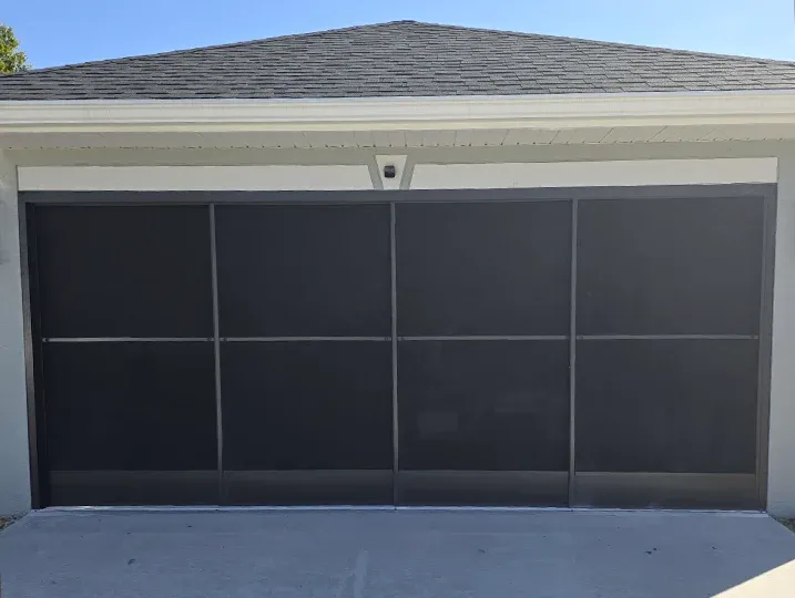 Retractable garage door screen installed on a residential home in The Treasure Coast, Florida, improving airflow while keeping insects out.